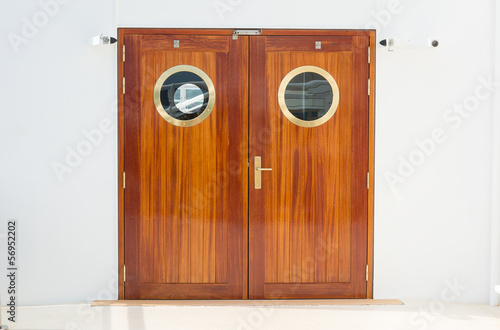 Closed wooden dobule doors with brass fittings