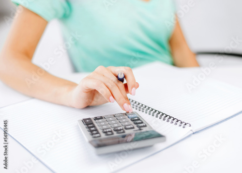 businesswoman working with calculator in office