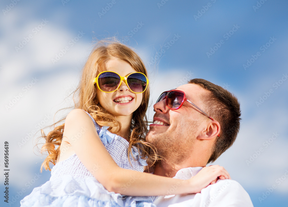 happy father and child in sunglasses over blue sky happy father and child in sunglasses over blue sky