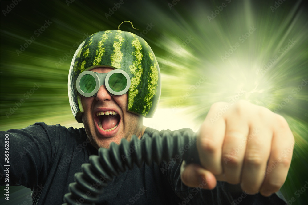 Fototapeta premium Bizarre man in a helmet from a watermelon
