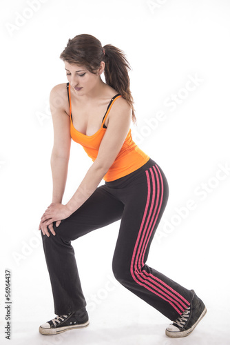 Young lady doing sport exercises, stretching and warming