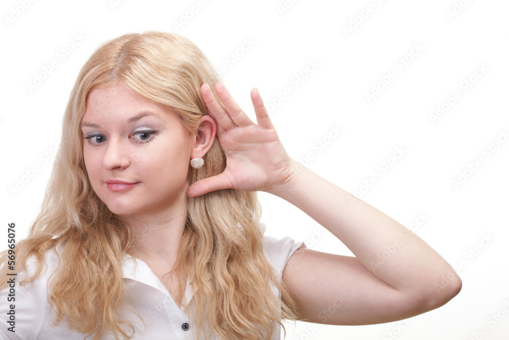 woman eavesdropping with hand behind her ear woman eavesdropping with hand behind her ear