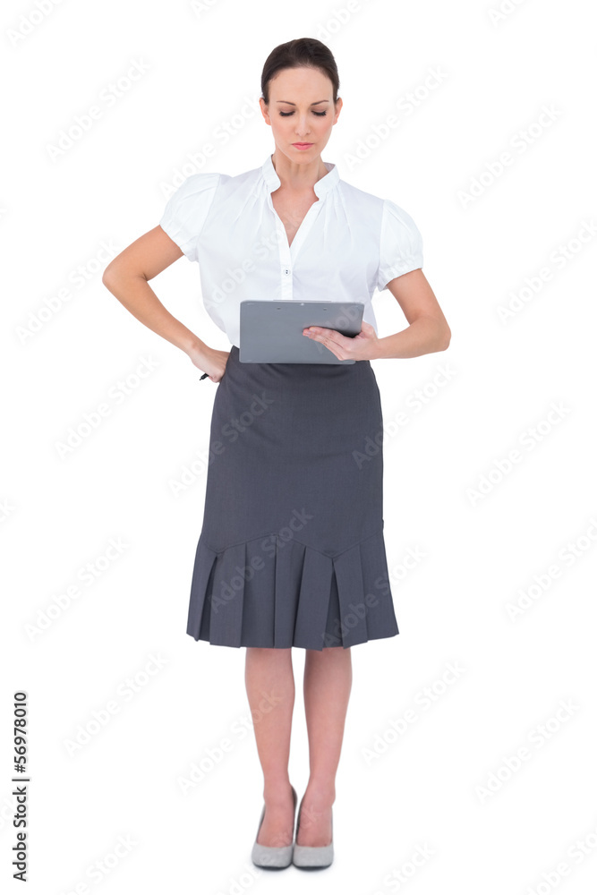 Focused businesswoman looking at her memo Focused businesswoman looking at her memo