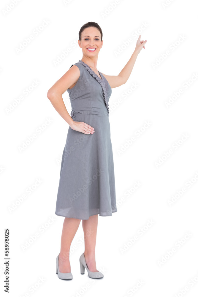 Happy gorgeous woman in classy dress pointing out direction Happy gorgeous woman in classy dress pointing out direction