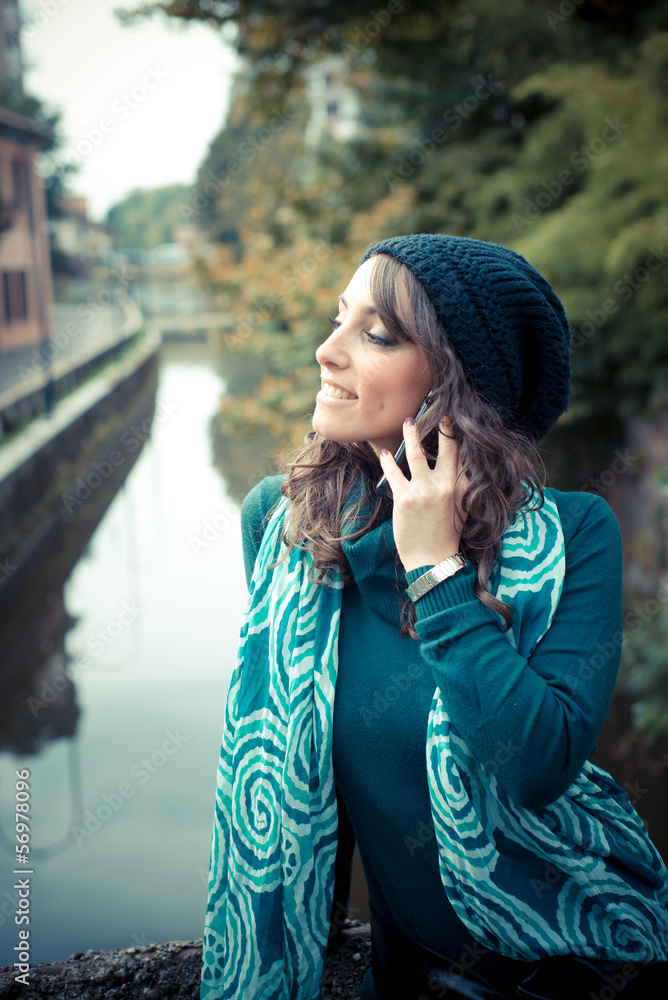 beautiful woman with turtleneck on the phone in the city beautiful woman with turtleneck on the phone in the city