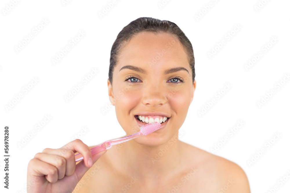 Smiling woman brushing her teeth Smiling woman brushing her teeth
