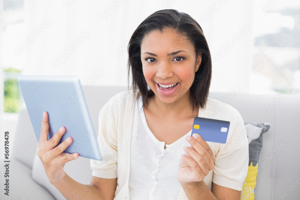 Happy young dark haired woman in white clothes shopping online w Happy young dark haired woman in white clothes shopping online w