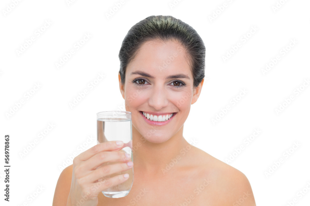 Smiling bare brunette holding glass of water Smiling bare brunette holding glass of water