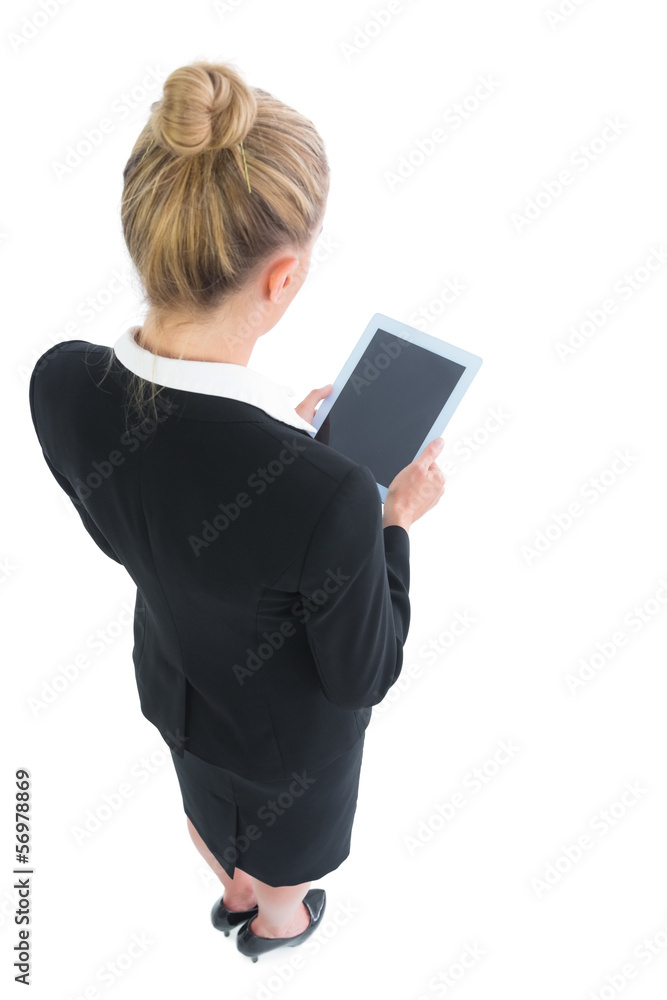 Blonde young businesswoman making use of her tablet Blonde young businesswoman making use of her tablet
