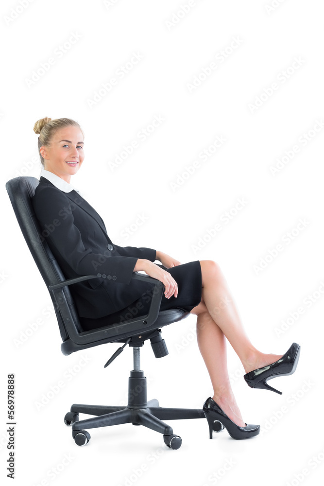 Gorgeous chic businesswoman sitting on an office chair Gorgeous chic businesswoman sitting on an office chair