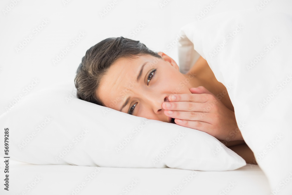 Tired casual brunette waking up and yawning Tired casual brunette waking up and yawning