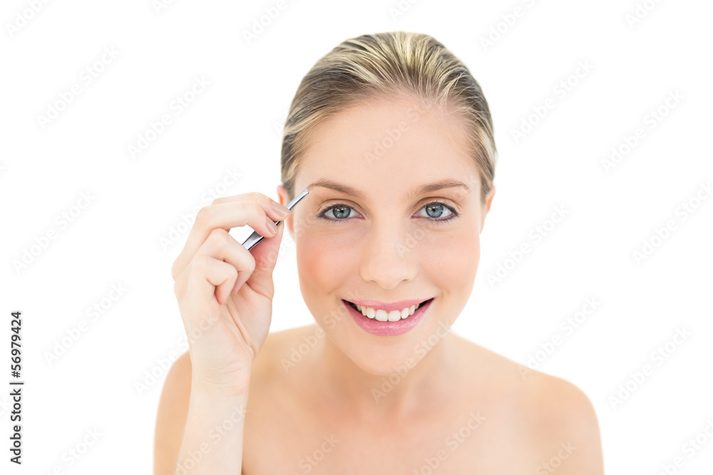 Joyful fresh blonde woman plucking her eybrows Joyful fresh blonde woman plucking her eybrows