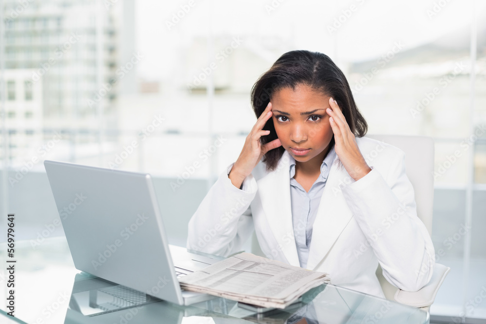 Puzzled young dark haired businesswoman trying to understand a d Puzzled young dark haired businesswoman trying to understand a d