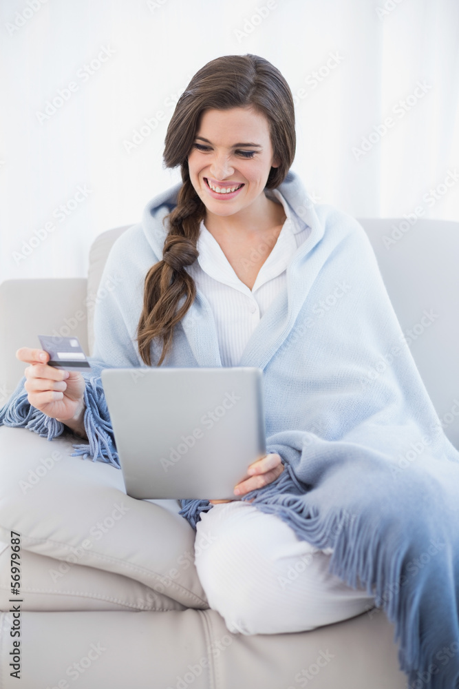 Cute casual brown haired woman in white pajamas shopping online Cute casual brown haired woman in white pajamas shopping online