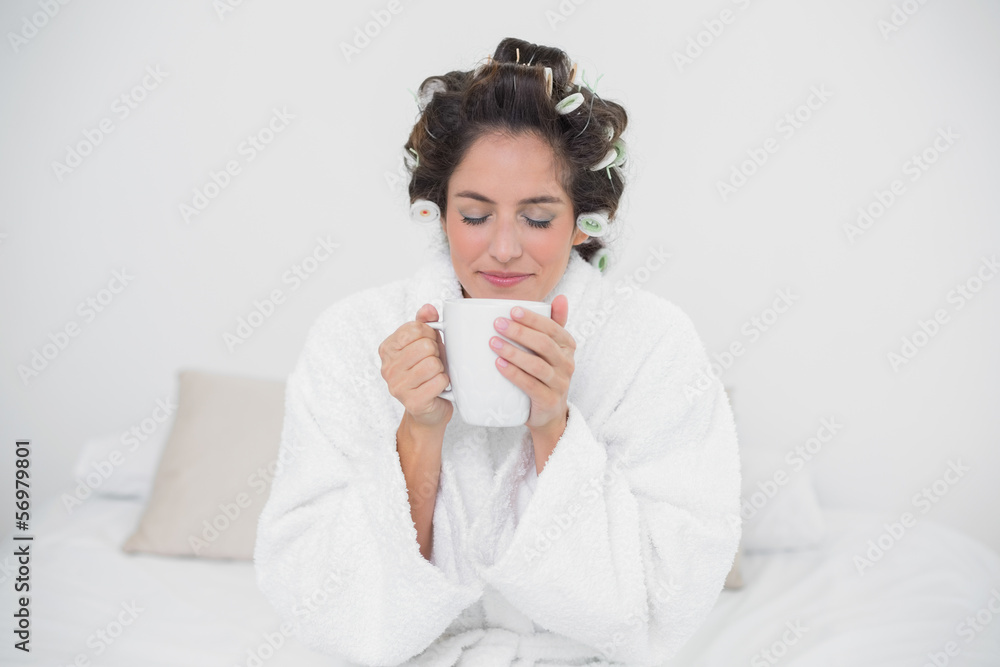 Peaceful natural brunette holding a mug Peaceful natural brunette holding a mug