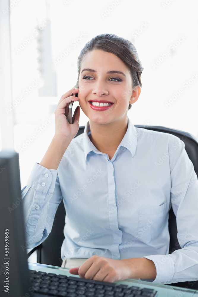 Content classy brown haired businesswoman making a phone call Content classy brown haired businesswoman making a phone call
