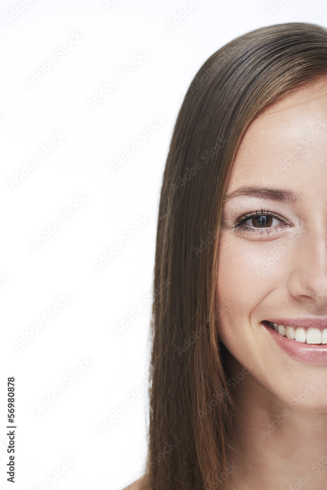 Portrait of young woman smiling against white background Portrait of young woman smiling against white background