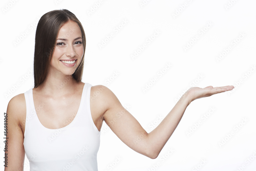 Portrait of young woman with arm out against white background Portrait of young woman with arm out against white background