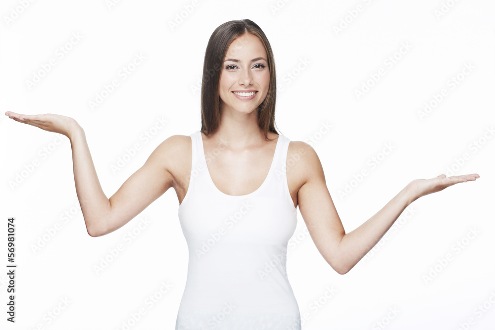 Portrait of young woman with arms out against white background Portrait of young woman with arms out against white background