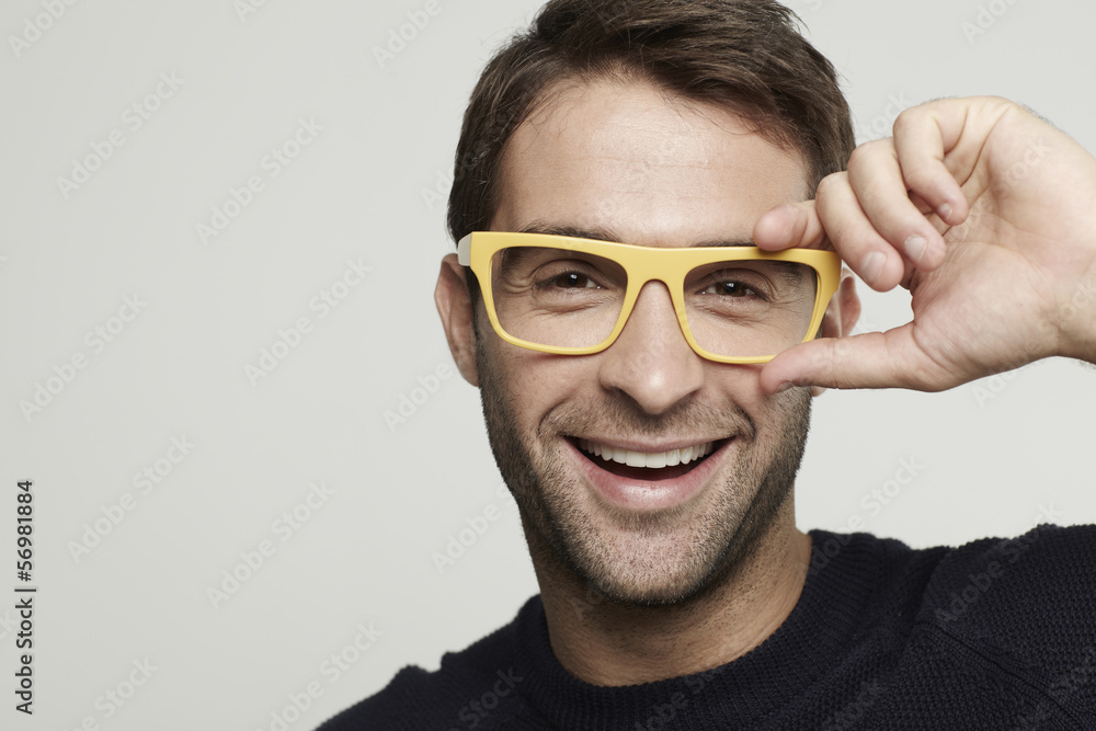 Portrait of mid adult man in yellow glasses Portrait of mid adult man in yellow glasses