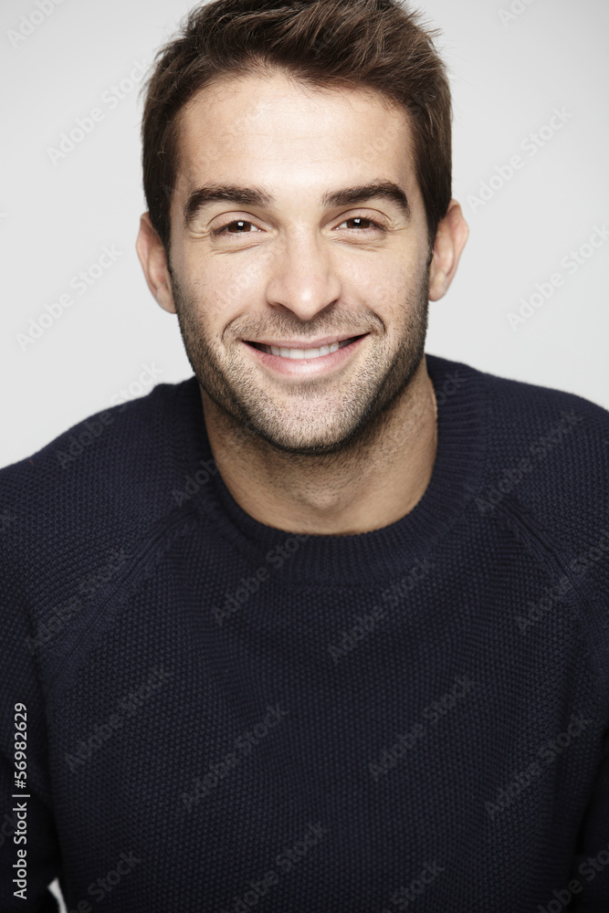 Portrait of mid adult man against grey background, smiling Portrait of mid adult man against grey background, smiling
