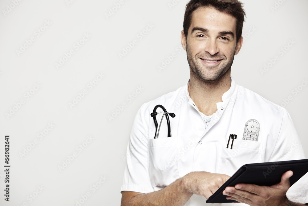 Portrait of mid adult doctor holding tablet Portrait of mid adult doctor holding tablet