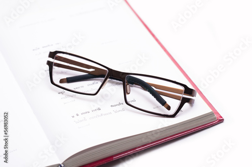 Close up eyeglasses on a document isolated
