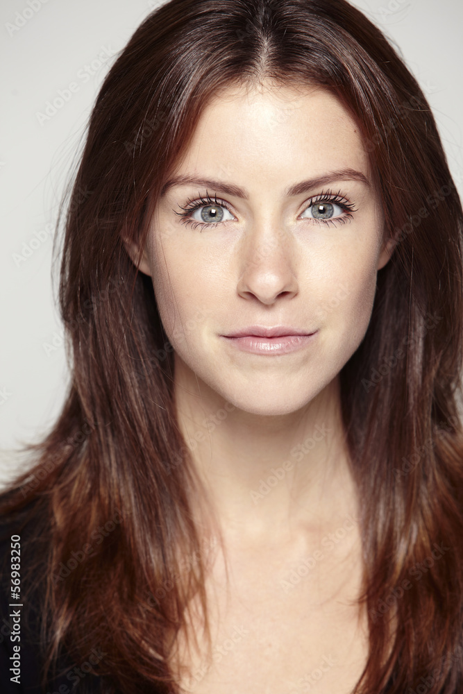 Portrait of a young woman on a gray background Portrait of a young woman on a gray background