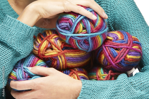 woman holding yarn rolls in her arms