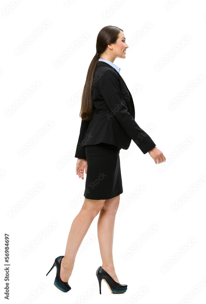 Full-length profile of walking business woman, isolated Full-length profile of walking business woman, isolated