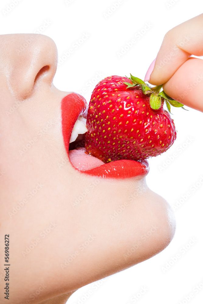 Obraz premium Close up of woman's mouth eating strawberry, isolated on white