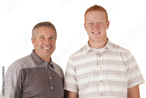 Father with adopted teenage son smiling looking into camera