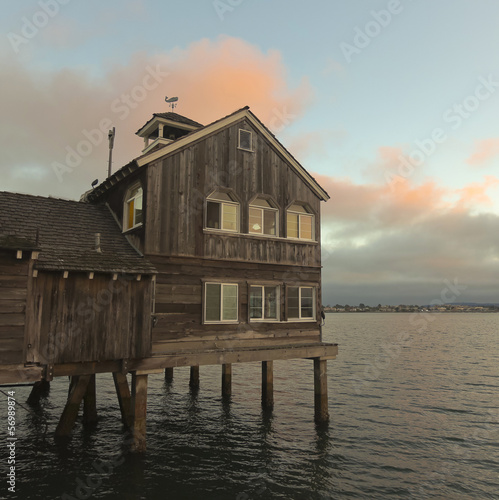 A House on a Pier at Sunset © Derrick Neill
