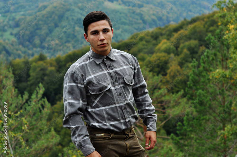young handsome man in mountains