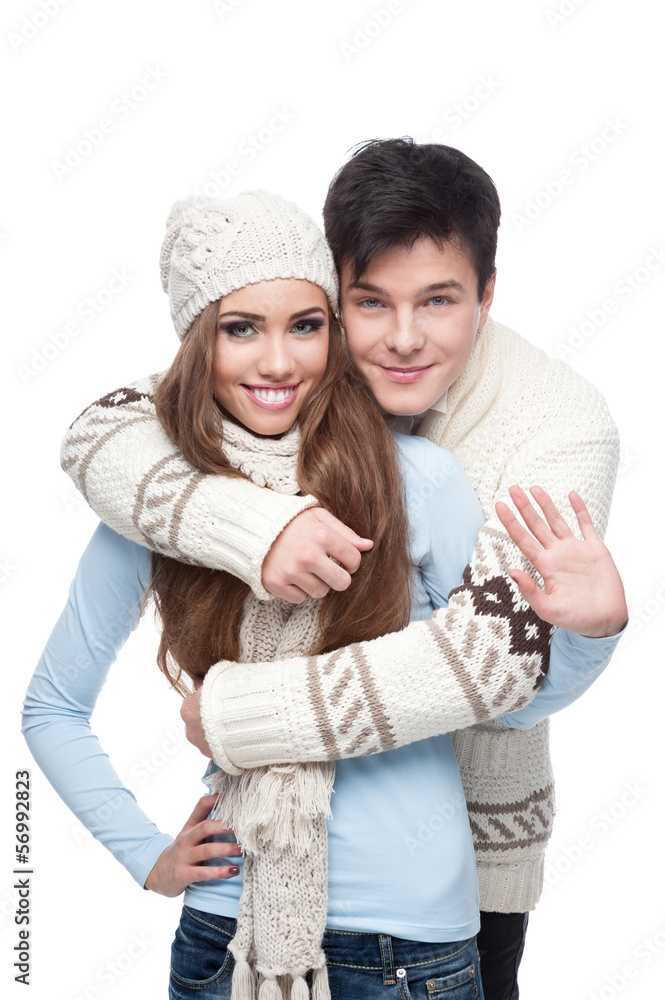 young smiling couple in winter clothing embracing young smiling couple in winter clothing embracing