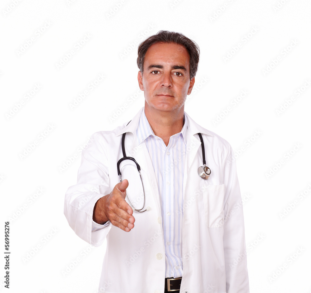 Charismatic doctor standing with greeting gesture Charismatic doctor standing with greeting gesture