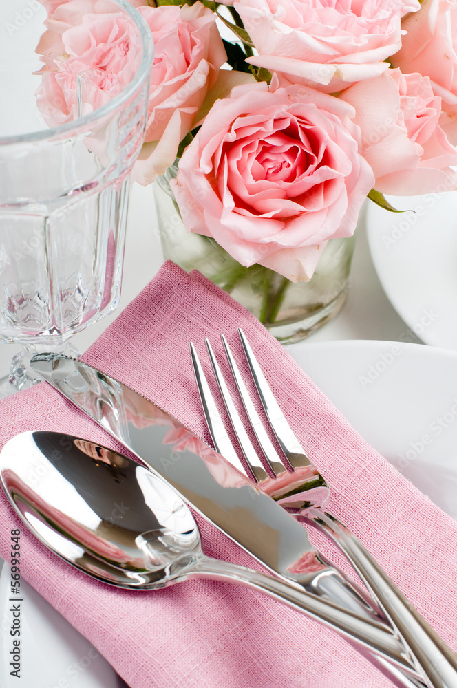Luxurious table setting with pink roses Luxurious table setting with pink roses