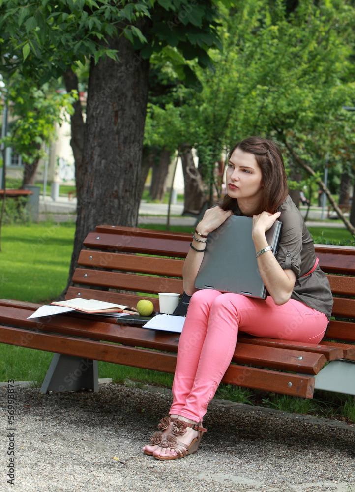 Young Woman with a Laptop in the Park Young Woman with a Laptop in the Park