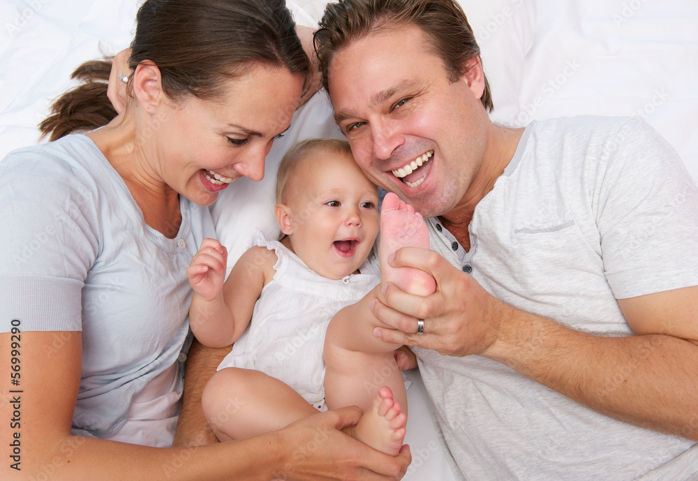 Portrait of a happy loving family playing with baby Portrait of a happy loving family playing with baby