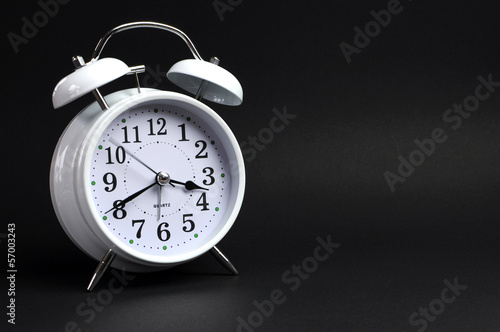 Wallpaper Mural White vintage alarm clock against black background Torontodigital.ca