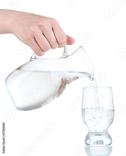 Glass pitcher of water and glass isolated on white