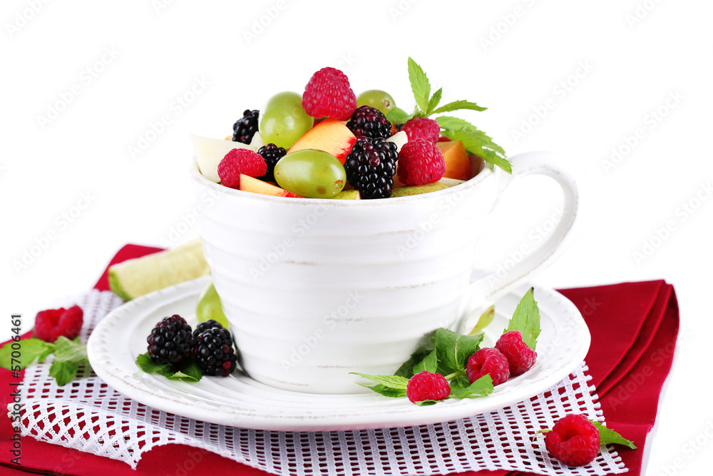Fruit salad in cup on napkin isolated on white Fruit salad in cup on napkin isolated on white