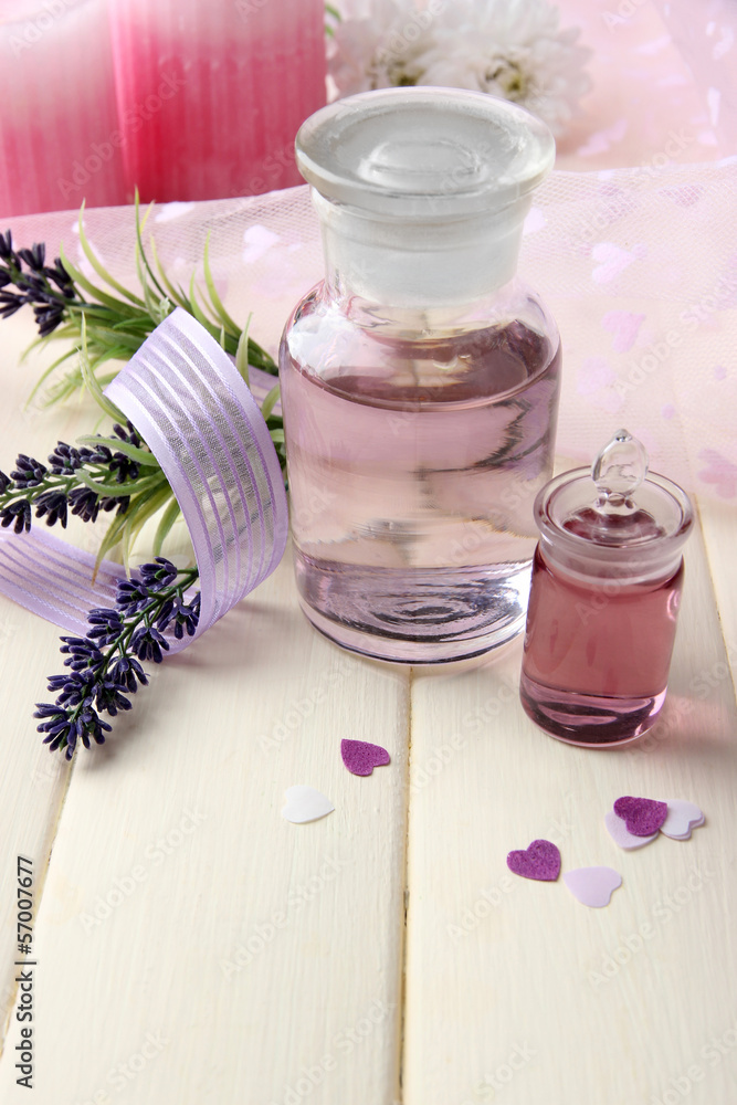 Glass bottle with color essence, on wooden background Glass bottle with color essence, on wooden background