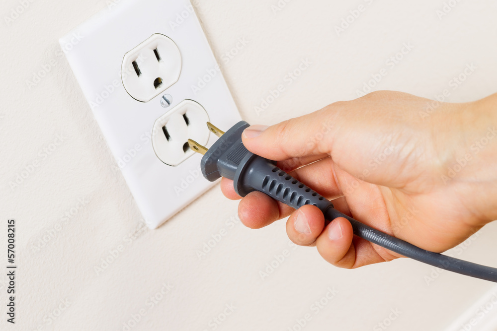 Φωτογραφία Inserting Power Cord Receptacle in wall outlet