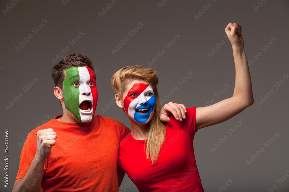 Couple of footbal fans. With face art in red T-shirts