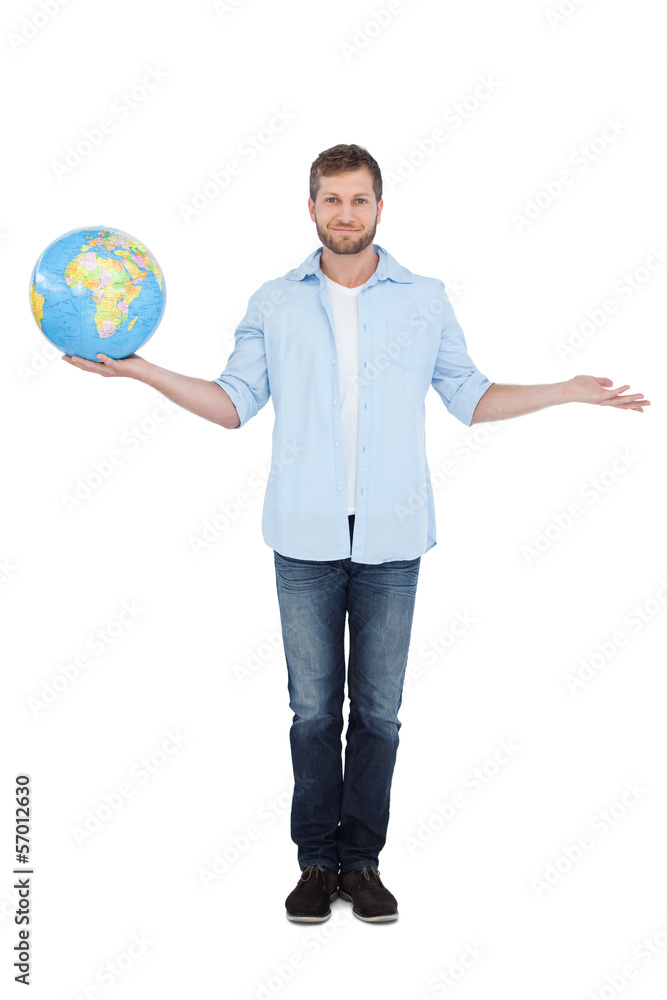 Charming young model holding a globe and looking at camera Charming young model holding a globe and looking at camera