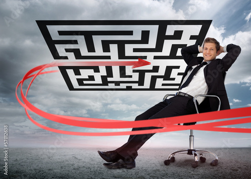 Businessman sitting in front of red arrow through qr code