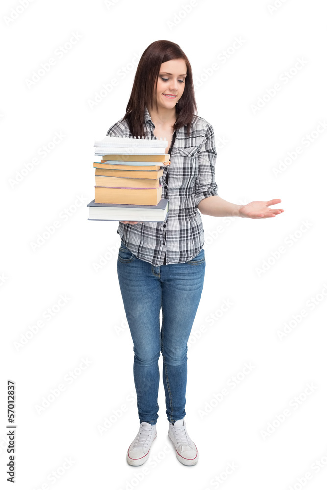 Smiling pretty student holding pile of books Smiling pretty student holding pile of books