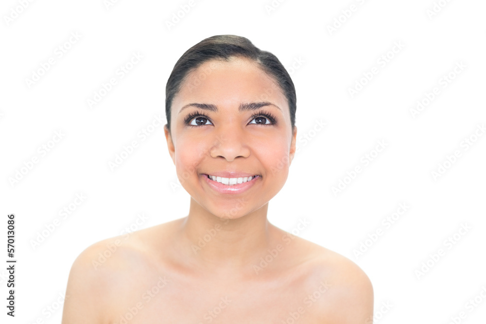 Pleased young dark haired model looking up