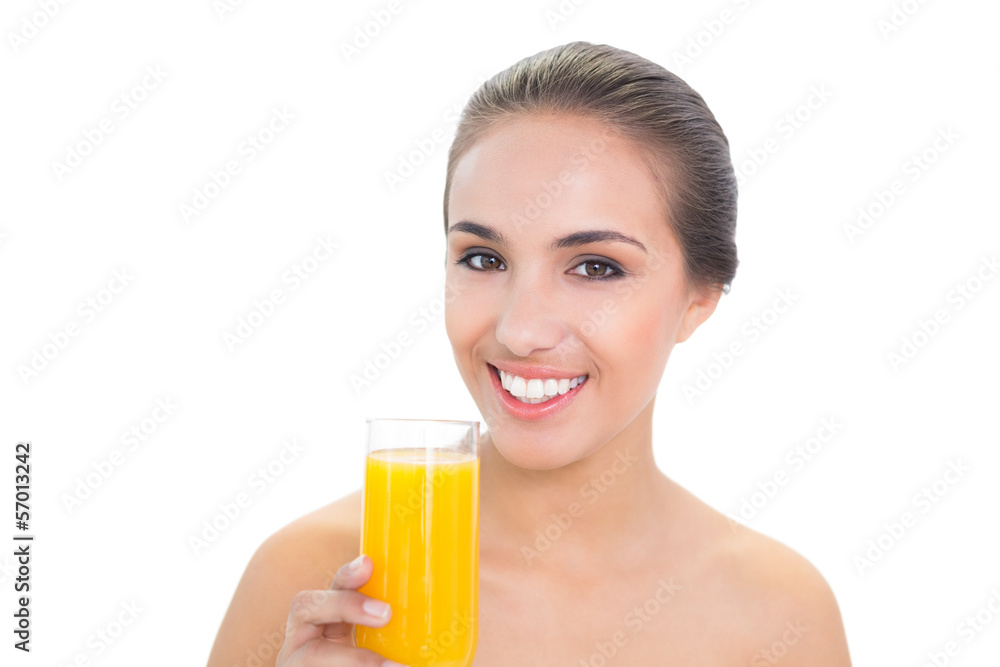 Cheerful brunette woman holding a glass of orange juice Cheerful brunette woman holding a glass of orange juice